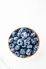 Blueberries in the bowl on white.