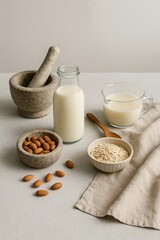 Homemade Plant-Based Milk Ingredients – Almond and Oat Milk Preparation Scene on Modern Rustic Kitchen Table