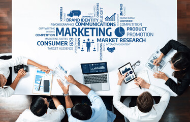 Professionals engaging in a marketing strategy session, analyzing data and insights for effective brand communication and audience engagement in a collaborative workspace. Amity