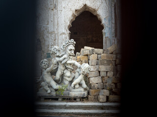 Fototapeta premium view to sculpture in yard of abandoned castle