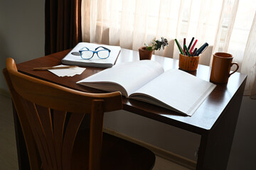 Study desk with open notebook and stationery