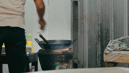 A person cooking on a traditional stove in an outdoor kitchen setting