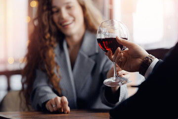 Romantic date of young caucasian couple in restaurant enjoying wine