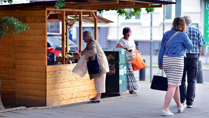 Szczecin, Poland. 16 July 2025. Crowds of people shopping at street vendors along the sidewalks