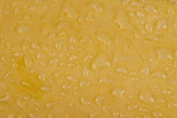 wet zucchini with a hard peel, ripe white zucchini on the kitchen table before cooking in drops of water