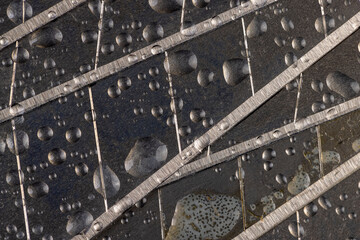 a wet steel blade for a knife , a sharp spare blade for a knife for repair work covered with water...