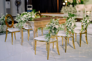 wedding table and chairs and white flowers