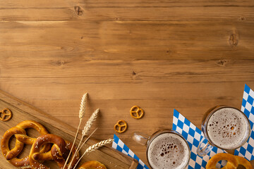 Rustic Oktoberfest arrangement featuring traditional pretzels, beer glasses, wheat stalks, and flat lay top view wooden surfaces