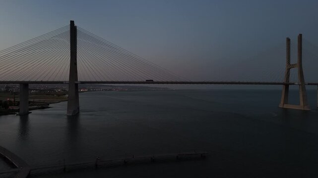 Aerial drone view of Vasco da Gama Bridge - the longest bridge in the European Union located in Lisbon, Portugal - sideways panning orbit