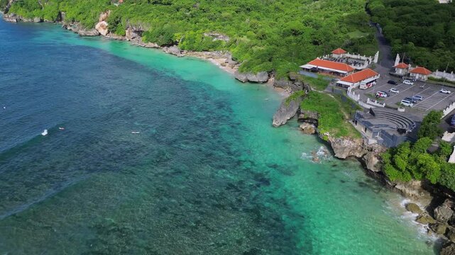 Aerial view of parking area with cars at seaside at sunny day. Geger beach. Nusa Dua. Bali. Indonesia