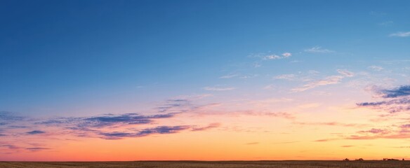 Obraz premium The Sunset Sky Over Wide Open Prairie with Soft Pastel Clouds and Horizon