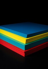 Colorful paper stacked against dark background