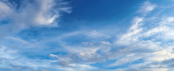 Fototapeta premium The Sky Filled with Wispy White Clouds and Soft Blue Atmospheric Light