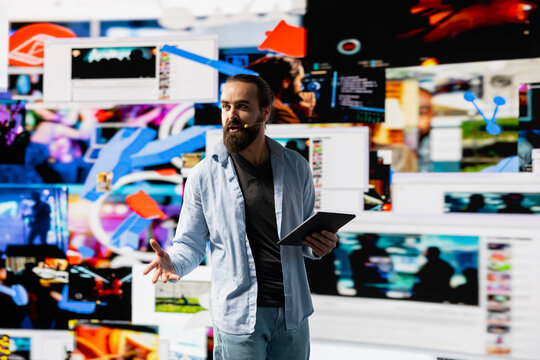 Young social influencer presenting a live discussion to a virtual audience, using visuals and user experience design to boost visibility and reach. Build brand voice in the digital online world.