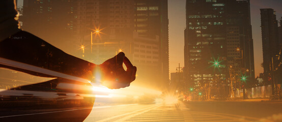 Person with a calm state of mind mediating in city setting 