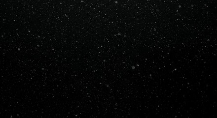 Abstract black background with white snow particles or dust specks creating atmospheric texture for overlay effects