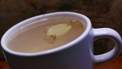 A ginger tea on the table. A cup of hot tea. A large cup of ginger tea. A tea mug, close-up shot.