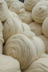 Ivory wool sliver coils in a textile mill close up