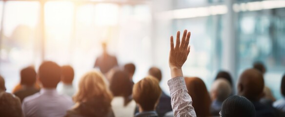 The Audience Member Raising a Hand During a Conference QandA in a Bright Room