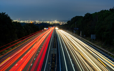 Light trails illuminating highway at dusk, showcasing dynamic transportation network