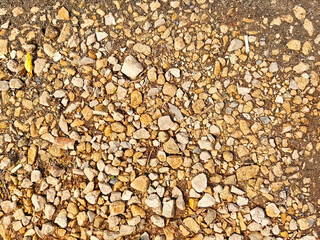 Natural gravel texture highlighting varied stone sizes and earthy tones with ample space for text or design elements