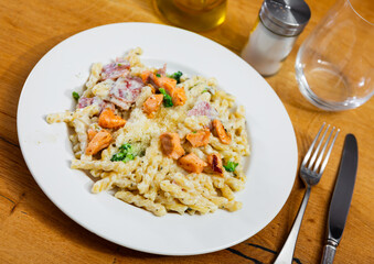 Plate of pasta cooked with salmon and bacon. Traditional Italian food