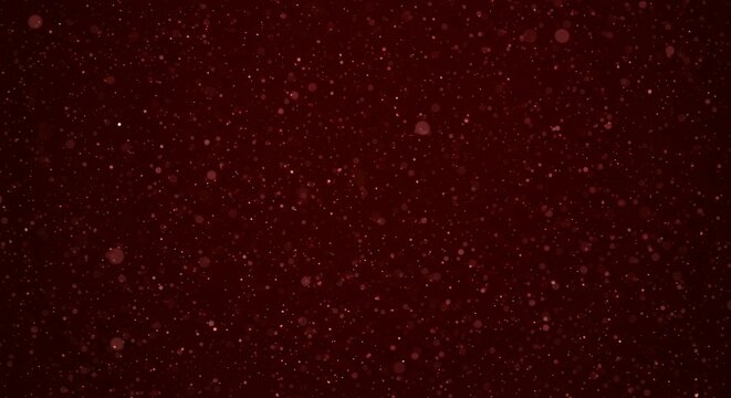 Dark burgundy red bokeh background with floating luminous particles and soft focus effect for luxury brand presentations