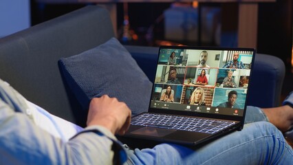 Smiling african american man hosting a virtual family meeting online via video conference, meeting...