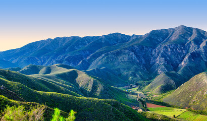 Narrow valley with vineyards, rolling hills, and Langeberg Mountains, Robertson, South Africa © Arnold