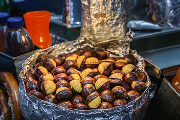 A pan of fresh roasted chestnuts on a street food cart in Manhattan, New York