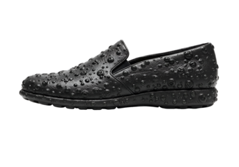 Black leather slip-on shoe covered in water droplets with high contrast background