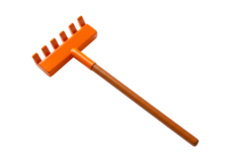 Bright orange plastic rake with long handle isolated on black background for gardening or outdoor