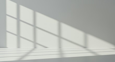Obraz premium Natural window shadows creating grid pattern on white wall surface, minimalist architectural lighting for contemporary interior backgrounds