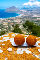 Arancini Sicilian, deep-fried rice balls made with risotto, filled with ingredients mozzarella,...