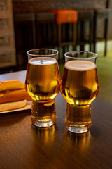 Freshly brewed light pils German beer in craft brewery served in beer glass poured from keg