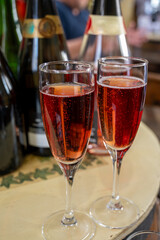 Pouring and tasting of rose or pink cuvee sparkling wine brut, grang reserve, champagne in Ay-Champagne wine making village in Vallee de la Marne, , Champagne region, France