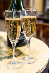 Pouring and tasting of dry sparkling wine brut, grand reserve, champagne in Ay-Champagne wine making village in Vallee de la Marne, , Champagne region, France