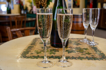 Pouring and tasting of dry sparkling wine brut, grand reserve, champagne in Ay-Champagne wine making village in Vallee de la Marne, , Champagne region, France