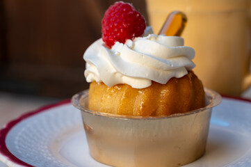 French cuisine, fresh baked baba au rum cake with chantilly cream, sweet dessert with rum close up