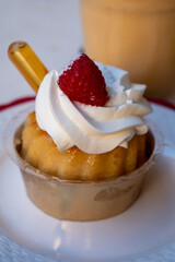 French cuisine, fresh baked baba au rum cake with chantilly cream, sweet dessert with rum close up
