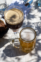 Belgian beer in glass in old brewery in Bruges, dubbel dark, tasty beverage, lunch with beer, tourist destination, Flanders, Belgium