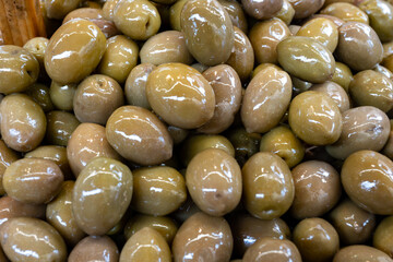 Homemade italian pickled green olives with garlic and spices on food market in Palermo, Sicily, italy