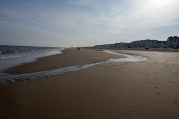 White sandy beach in cosy seaside holiday village on North Sea, built in belle epoque style in Flanders, De Haan or Le Coq sur Mer, Belgium