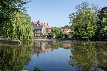 Obraz premium Views of lake and city park with beautiful old buildings in Bruges, Flanders, Belgium, travel destination