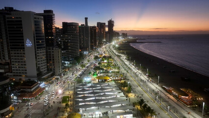 Sunset Beira Mar Beach At Fortaleza In Ceara Brazil. Sunset City. Downtown District. Beira Mar Beach At Fortaleza In Ceara Brazil. Illuminated Cityscape. Drone Aerial View. © bydronevideos