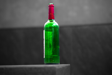 Green Wine Bottle with Red Neck on table