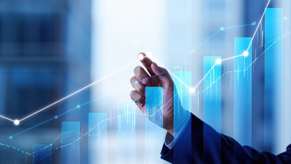 Visualizing Financial Growth A Hand Pointing at Rising Bar Graphs and Lines on a Blue Background Representing Market Trends and Economic Development with Clarity and Insight