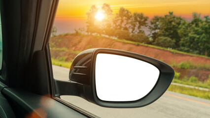 Obraz premium wing mirror car on the asphalt highway on sunset.