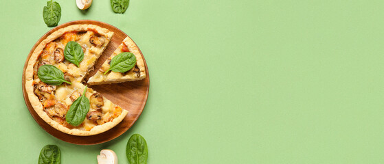 Mushroom pie with spinach leaves and champignons on green background