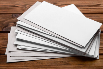 Stack of letters on wooden background, closeup